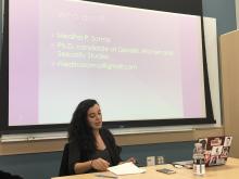 Mediha Sorma presenting in front of her powerpoint in the NELC seminar room