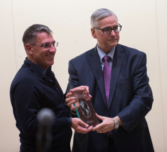 Ali Igmen receiving award from John Keeler, the dean of the Graduate School of Public and International Affairs at the University of Pittsburg