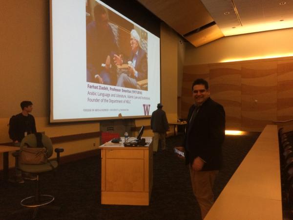 Professor Lior Sternfield standing near the podium before his presentation